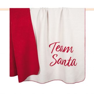 kuschelweiches Plaid in weiß mit roter Aufschrift "Team Santa" am unteren rechten Rand, Abseite rot